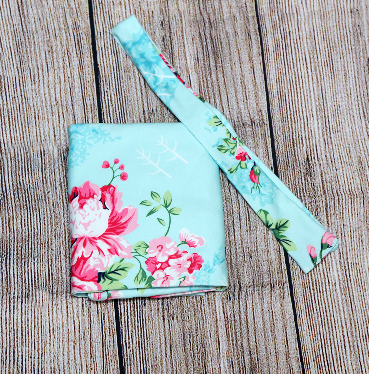 Green floral swaddle set with matching headband and hat